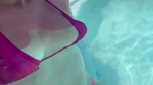 Artemisia Love wearing a wrath bathing suit in the outdoor jacuzzi